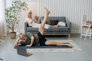 man doing mat pilates at home