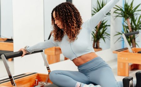 woman stretching on pilates reformer
